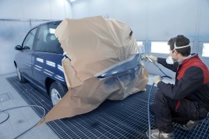 worker painting a car